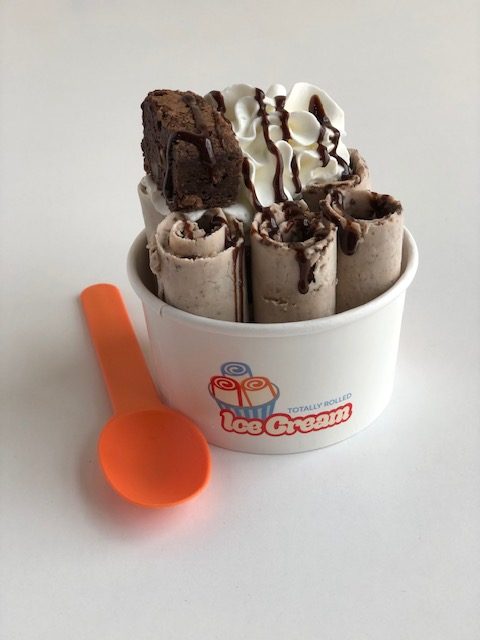 Decadent brownie ice cream with fudge pieces and chocolate swirls